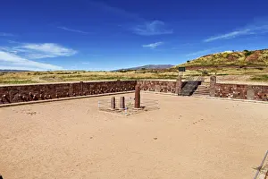 Ancient Civilization Sites Prints: A rectangular square with stone pillars surrounded by ruins under a clear sky