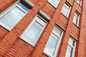 Deserted Building Wall Prints: Red brick building wall with clouds reflections in windows