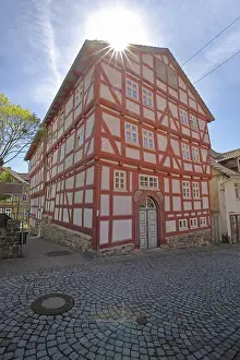 Historic Quarter Germany Prints: Red frame house with back light