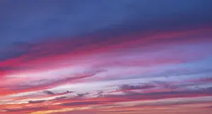 Cloudy Evening Light Prints: Red glowing clouds in the evening light at sunset