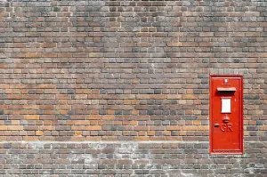 Empty Brick Walls Prints: Red mail box in a brick wall