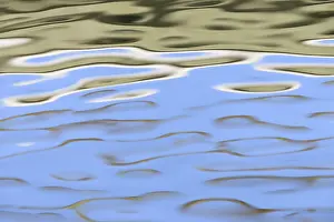 Wavy Water Surface Prints: Reflection of cloudy sky on the wavy water surface