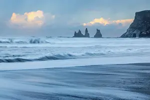 Cloudy Sky Coastal Scene Prints: Reynisdrangar pinnacles, lava sandy beach