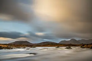 Glen Coe Mountain Peaks Prints: River Ba with mountain peaks in the background and dramatic clouds