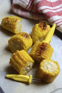 Corn Still Life Photography Prints: Roasted corn on the corn cob with corn on the cob holder