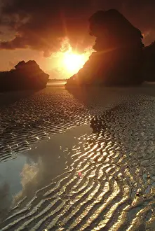 Low Tide Beach Scene Prints: Rock formation on the beach at sunset