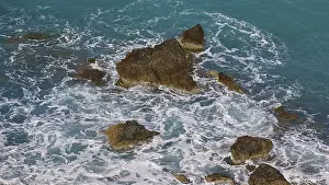 Mediterranean Coastal Scene Prints: Rocks in the sea, surrounded by spray and surging waves