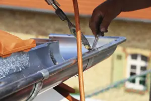 Close Up Gutter Detail Prints: Roofer doing tinsmith work on a gutter