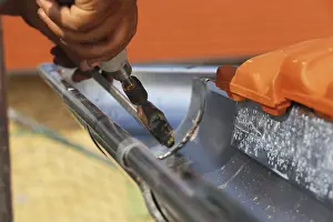 Close Up Gutter Detail Prints: Roofer doing tinsmith work on a gutter