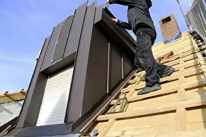 Stainless Steel Roofing Materials Prints: Roofer working on a new dormer window