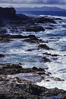 Rocky Coast Of Spain Prints: Rough sea with waves hitting cliffs under cloudy sky