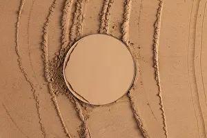 Compact Powder Prints: A round block of compact powder