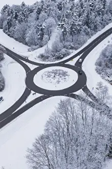 Winter Road Traffic Germany Prints: Roundabout, surrounded by snowy trees