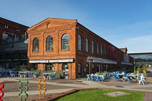 Prints of Rows of cafe tables in front of a long brick building, Manufaktura, Łodź, Lodz, Lodz, Poland Rows of caf tables in front of a long brick building, Manufaktura, ?d?, Lodz, Lodz, Poland Lodz Prints: Manufaktura Brick Building Print, Lodz, Poland