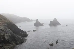 Northern Europe Coastlines Prints: Rugged cliffs off the coast in the mist