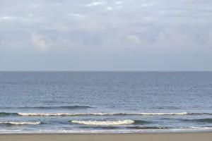 Empty Sandy Ocean Beach Prints: Running out waves at the sandy beach