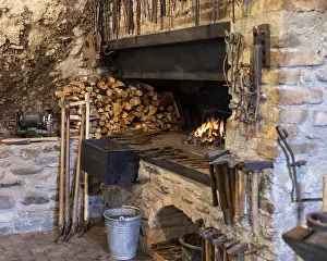Traditional Craftsman Tools Prints: A rustic blacksmith workshop featuring a burning forge