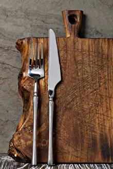 Rustic Wooden Cutting Board Prints: Rustic wooden cutting board on rusty stone background