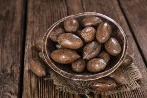 Pecan Nuts Prints: Rustic wooden table with some Pecan Nuts (selective focus)