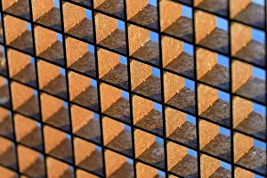 Industrial Architecture Europe Prints: Rusty grid against a blue sky, background image