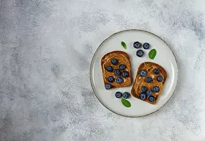 Healthy Eating Habits Images Prints: Rye bread with peanut paste and fresh blueberries