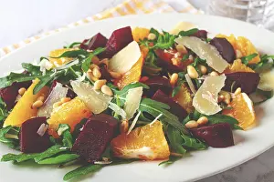 White Plate With Striped Napkin Prints: A salad made with chunks of beet