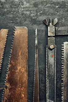 Handicraft Tools Prints: Saws on metal surface. Rusty tools for maintenance
