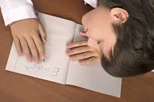 Education Background Image Prints: Schoolboy sleeping on the table with notebook