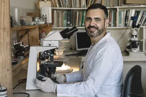 Scientist In Lab Prints: Scientist in front of microscope