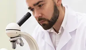 One Person Lab Prints: Scientist is using microscope in a laboratory during research work