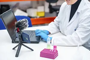 Medical Diagnosis And Inspection Prints: Scientists using mobile to recording while talking next to samples and using laptop in a research laboratory