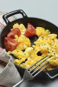 Scrambled Eggs Prints: Scrambled eggs with tomatoes in a pan