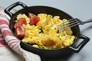 Chicken Eggs Nutrition Prints: Scrambled eggs with tomatoes in a pan