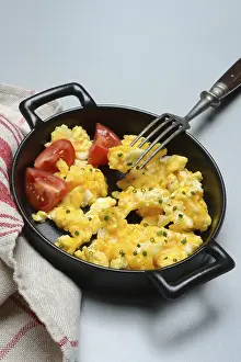 Scrambled Eggs Prints: Scrambled eggs with tomatoes in a pan
