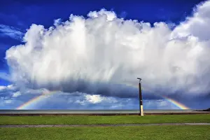 Cloudy Sky With Rainbow Colors Prints: Seaside promenade, dramatic cloudy sky with rainbow