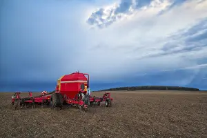 Deserted Agricultural Land Prints: Seeding machine on the empty field before storm