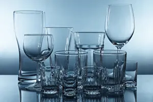 Blue Background Cutout Prints: Set of different empty glasses on blue background