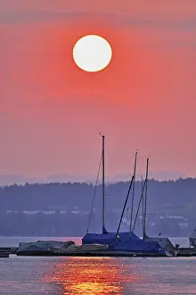 Evening Sun Sky Prints: Setting sun over the boat harbour