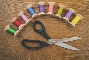 Handicraft Symbolism Prints: Sewing concept. Scissors and colorful thread spools