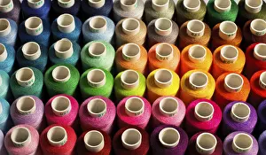 Multicolored Threads Prints: Sewing threads as a multicolored background close up