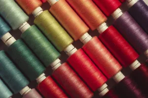 Multicolored Threads Prints: The sewing threads multicolored background close up