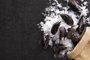 Appetizing Seafood Starters Prints: Shells on ice on brown burlap bag