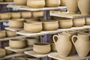 Deserted Studio Prints: Shelves with ceramic dishware in pottery workshop
