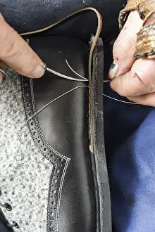 European Handicrafts Prints: Shoemaker, midsole is pierced with awl and needle with thread are pulled through