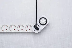 Electricity Supply Industry Prints: Top shot of a timer in a power strip on a white Resopal panel