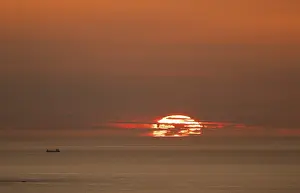 Evening Light Silhouette Prints: Silhouette of a ship in front of the setting sun