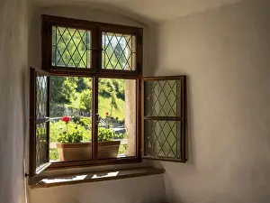 Deserted Stone Wall Prints: Simple window wiht flower box in solid stone wall in old castle