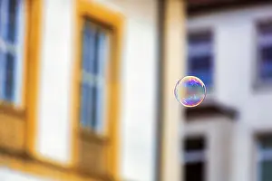 Prints of Single soap bubble floating in the city centre, Bielefeld, Germany Bielefeld Prints: Single Soap Bubble Print, Bielefeld City Centre