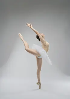 Elegant Pose Prints: A skilled ballet dancer gracefully leaps in a studio