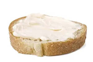 Bread And Dairy Products Prints: Slice of bread with cheese cream spread on it